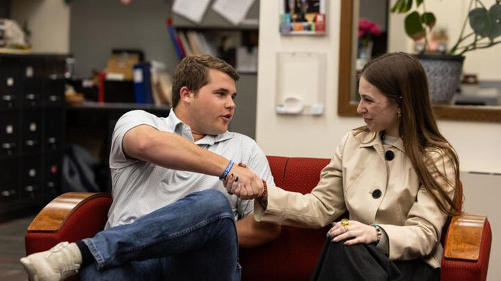ASUN President-elect Kurt Schneider shakes hands with Nexus presidential candidate Kyanne Casperson, after he was announced the winner of the election in the ASUN office on Wednesday, April 1, 2026, in Lincoln.  Photo by Justin Diep.